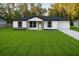 Charming single-story home with a well-manicured lawn and neutral-tone exterior at 5 Laurel Pass Ln, Ocala, FL 34472
