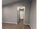 Hallway with wood-look tile flooring leading to the bathroom at 5 Laurel Pass Ln, Ocala, FL 34472