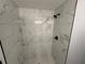 The walk-in shower features marble-look tile and dual shower heads at 5 Laurel Pass Ln, Ocala, FL 34472