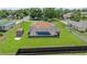 Aerial shot of the backyard featuring a pool with a screen enclosure, shed, and green lawns at 501 Marion Oaks Dr, Ocala, FL 34473