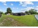 Spacious backyard featuring a pool with a screen enclosure, storage shed, and a well-manicured lawn at 501 Marion Oaks Dr, Ocala, FL 34473