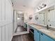 Bathroom featuring granite counters, large mirror and a white barn door at 501 Marion Oaks Dr, Ocala, FL 34473