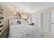 Bright bedroom with a white bed and built-in closet, complemented by a cozy study area and charming decor at 501 Marion Oaks Dr, Ocala, FL 34473