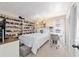 Bright bedroom with a white bed, built-in shelving displaying an extensive horse collection, and a cozy study area at 501 Marion Oaks Dr, Ocala, FL 34473