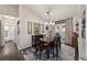 Inviting dining room with stylish chandelier, area rug, and access to the backyard at 501 Marion Oaks Dr, Ocala, FL 34473