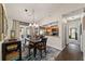 Cozy dining area featuring a dark wood table, access to the pool, and view to the kitchen at 501 Marion Oaks Dr, Ocala, FL 34473