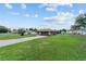Ranch-style house with an attached two-car garage and spacious front lawn under a blue sky at 501 Marion Oaks Dr, Ocala, FL 34473