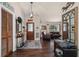 Inviting foyer with dark wood floors, decorative mirror, and view into the living room at 501 Marion Oaks Dr, Ocala, FL 34473