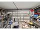 Attached garage with cluttered shelves, storage, and a white garage door at 501 Marion Oaks Dr, Ocala, FL 34473