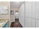 Hallway view of bathroom with a barn door and modern vanity with granite counters at 501 Marion Oaks Dr, Ocala, FL 34473
