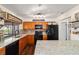 Well-lit kitchen with granite counters, updated cabinets, and black appliances at 501 Marion Oaks Dr, Ocala, FL 34473