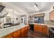 Modern kitchen with stone counters, wood cabinets, and an open view of the dining area at 501 Marion Oaks Dr, Ocala, FL 34473