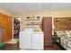 Functional laundry area with washer, dryer, and convenient access to the closet at 501 Marion Oaks Dr, Ocala, FL 34473