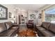 Bright living room with hardwood floors, leather sofa, and view toward the front entry at 501 Marion Oaks Dr, Ocala, FL 34473