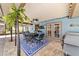 Charming screened patio features a dining set, grill, and ceiling fans overlooking the pool at 501 Marion Oaks Dr, Ocala, FL 34473