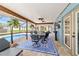 Inviting screened patio with a dining set, grill, ceiling fans, overlooking the pool at 501 Marion Oaks Dr, Ocala, FL 34473