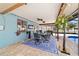 Relaxing covered patio with a ceiling fan, bar area, and outdoor dining set at 501 Marion Oaks Dr, Ocala, FL 34473