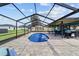 An in-ground pool within the screened-in lanai is adjacent to the home and covered patio at 501 Marion Oaks Dr, Ocala, FL 34473