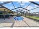 An in-ground pool is the focal point of a spacious screened-in lanai at 501 Marion Oaks Dr, Ocala, FL 34473