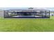 Enclosed inground pool surrounded by green lawn, screened-in enclosure, and blue home exterior at 501 Marion Oaks Dr, Ocala, FL 34473