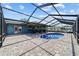 The covered patio offers outdoor dining and transitions to the pool and screened-in lanai at 501 Marion Oaks Dr, Ocala, FL 34473