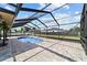 An in-ground pool is surrounded by a spacious screened-in lanai with pavers at 501 Marion Oaks Dr, Ocala, FL 34473