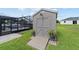 Side view of shed with a ramp, potted plants, and an enclosed pool in the background at 501 Marion Oaks Dr, Ocala, FL 34473