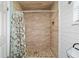 Walk-in shower featuring tile surround, a pebble floor and a shower curtain at 501 Marion Oaks Dr, Ocala, FL 34473