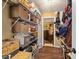 Organized storage room with shelves, baskets, and access to a small office space at 501 Marion Oaks Dr, Ocala, FL 34473