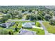 A beautiful aerial view shows the home's fenced backyard with swimming pool and the surrounding community and landscaping at 5459 Sw 86Th St, Ocala, FL 34476