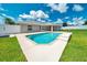 A sparkling in-ground pool provides the centerpiece for a spacious backyard, perfect for relaxation and entertainment at 5459 Sw 86Th St, Ocala, FL 34476