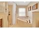 Bright bathroom with a large soaking tub and separate shower with glass door at 5459 Sw 86Th St, Ocala, FL 34476