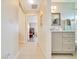 Neutral bathroom with tile floor, stylish vanity and a decorative mirror at 5459 Sw 86Th St, Ocala, FL 34476