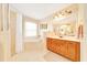 Bright bathroom featuring a bathtub, shower, spacious vanity with cabinets and a large mirror at 5459 Sw 86Th St, Ocala, FL 34476