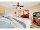 Comfortable bedroom featuring a ceiling fan, large closet, and complementing furnishings and decor at 5459 Sw 86Th St, Ocala, FL 34476