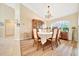 Elegant dining room with chandelier, hardwood floors, and fine china cabinet at 5459 Sw 86Th St, Ocala, FL 34476