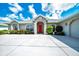 Charming single-story home with a well-manicured lawn and a welcoming red front door at 5459 Sw 86Th St, Ocala, FL 34476