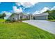 Charming home featuring a well-manicured lawn, mature plantings, long driveway, and a welcoming front entry at 5459 Sw 86Th St, Ocala, FL 34476