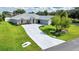 Well maintained home with a long driveway and lush green lawn at 5459 Sw 86Th St, Ocala, FL 34476