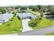 Beautiful single-story home boasts a well-manicured lawn and a lengthy driveway leading to a charming red front door at 5459 Sw 86Th St, Ocala, FL 34476