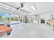 Spacious and tidy two-car garage features storage racks, water heater, and outside view at 5459 Sw 86Th St, Ocala, FL 34476