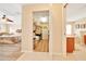 Hallway view with walk-in closet and a glimpse into the primary bathroom at 5459 Sw 86Th St, Ocala, FL 34476