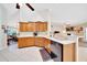 Functional kitchen features wooden cabinets, modern appliances, and an open layout with dining area, perfect for cooking at 5459 Sw 86Th St, Ocala, FL 34476