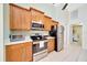 Kitchen features stainless steel appliances, wooden cabinets, and ample counter space at 5459 Sw 86Th St, Ocala, FL 34476