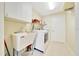 Bright laundry room with a utility sink, washer, and dryer for efficient cleaning and organization at 5459 Sw 86Th St, Ocala, FL 34476