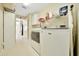 Functional laundry room with a washer, dryer, and storage shelves for added convenience at 5459 Sw 86Th St, Ocala, FL 34476