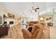 Spacious living room with vaulted ceilings, fireplace, ceiling fans, and wood-look floors at 5459 Sw 86Th St, Ocala, FL 34476