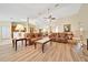 Bright living room features wood floors, ceiling fan, and comfortable seating, perfect for relaxing or entertaining at 5459 Sw 86Th St, Ocala, FL 34476