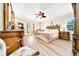 Main bedroom featuring a ceiling fan, furnishings, and natural light from the windows at 5459 Sw 86Th St, Ocala, FL 34476