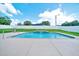 Sparkling pool with a waterfall feature in a beautifully maintained backyard oasis at 5459 Sw 86Th St, Ocala, FL 34476